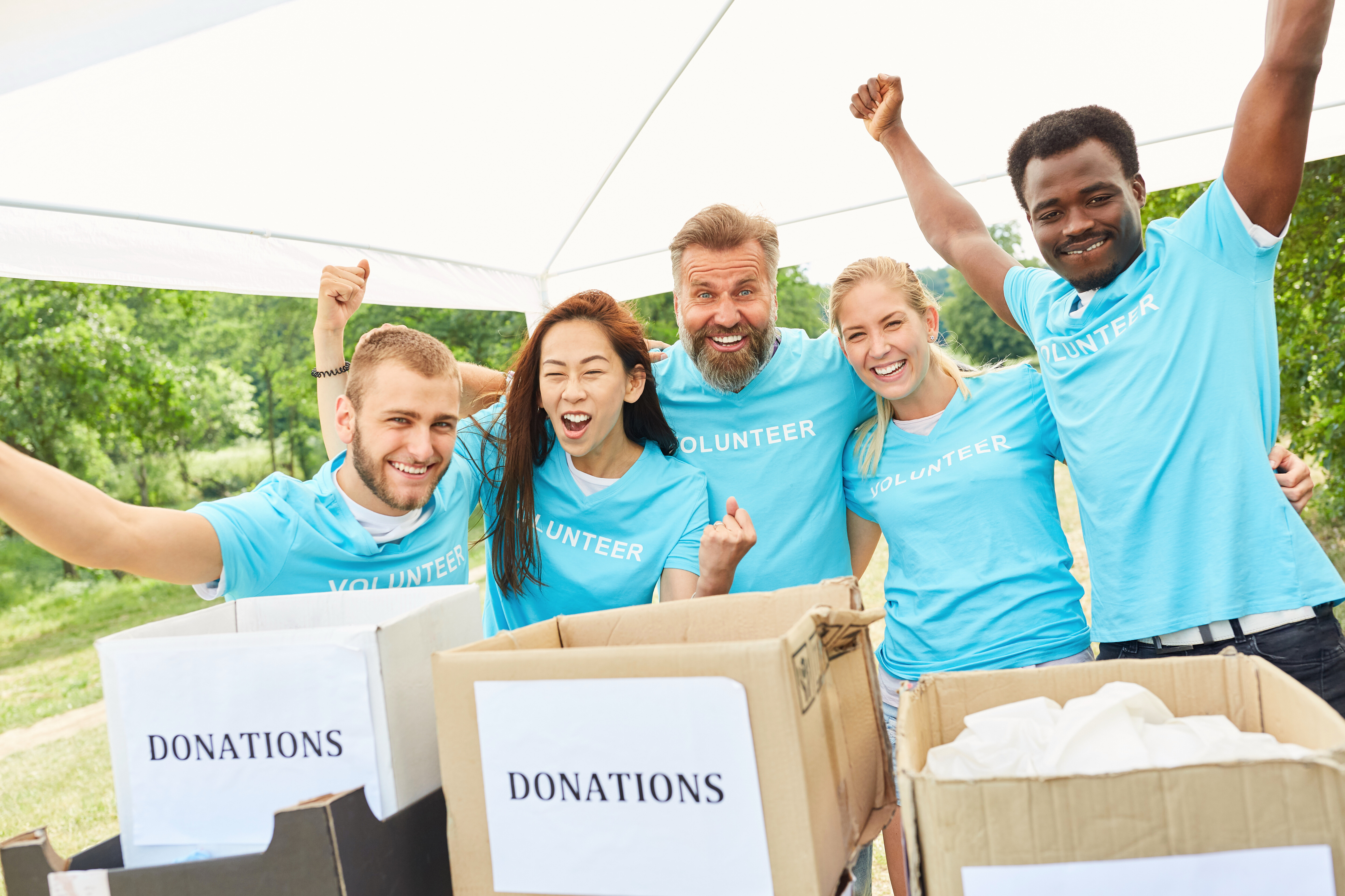 Team of five volunteers who are collecting donations are cheering due to excitement. This could be due to the AI tools utilized by the nonprofit to enhance donor engagement.