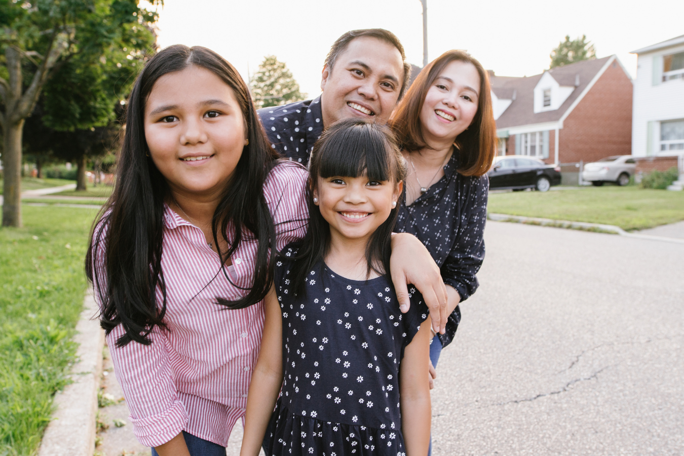 A family of Asian individuals including a Mother, a Father, and two daughters smile towards the photo. Sparkrock 365 is an ERP solution that ensures family service organizations can streamline administrative tasks.