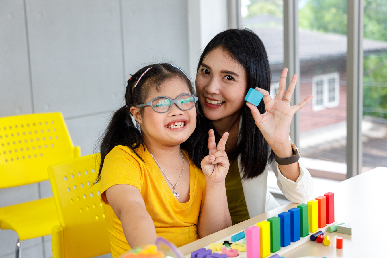 A foster family - a Mother and a Daughter with Down Syndrome - play with clay together. Real time access to data can be a single source of truth for family services organizations who utilize Sparkrock 365 as their ERP.