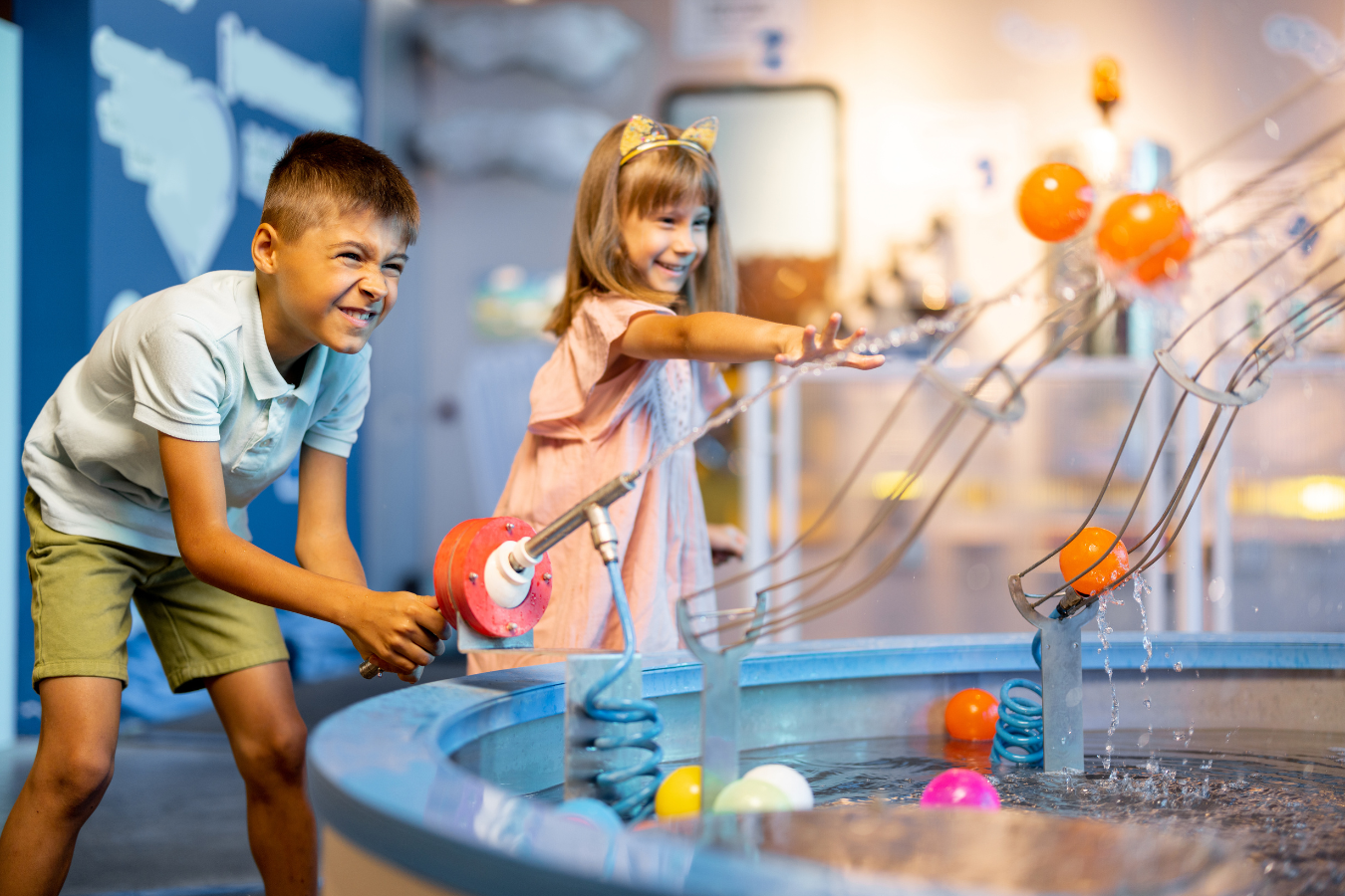 Two kids enjoy time playing in a science centre. Arts and culture organizations can thrive in a post-pandemic world through the integration of ERP software like Sparkrock 365.