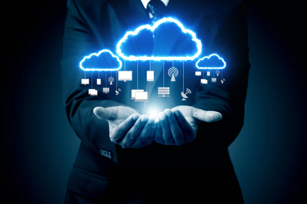 Business professional holding digital cloud icons representing ERP migration to the cloud