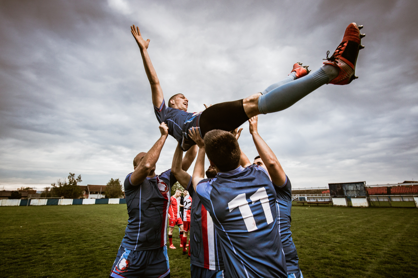 A jubilant soccer team celebrating victory. Sparkrock 365 ERP empowers sports associations, optimizing efficiency for enhanced member engagement with ample time and resources.