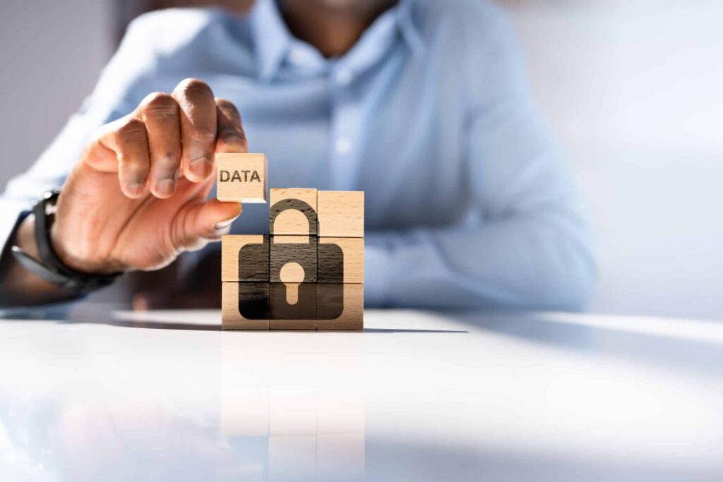 An image of a person putting a block that says "Data" in the top right of a 9 piece block puzzle that has a lock on the other, in place, 8 pieces.
