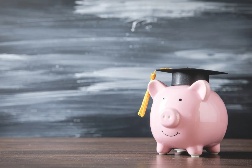 Piggy bank wearing graduation cap symbolizing school district budgets and financial management in K–12 education.