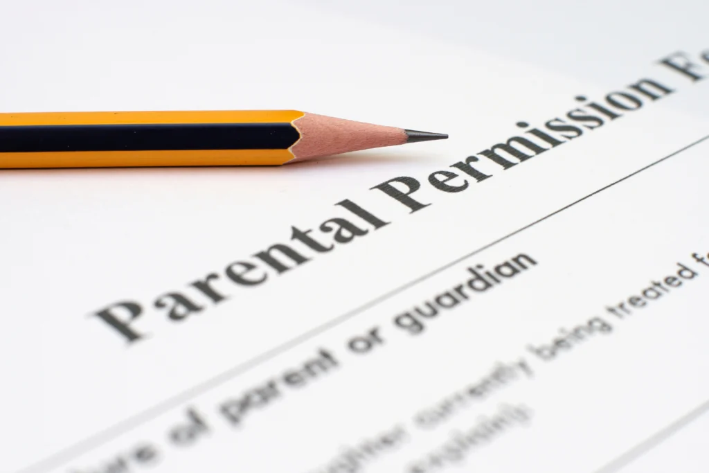 Parental permission form with pencil, representing digital school forms and online registration for school activities