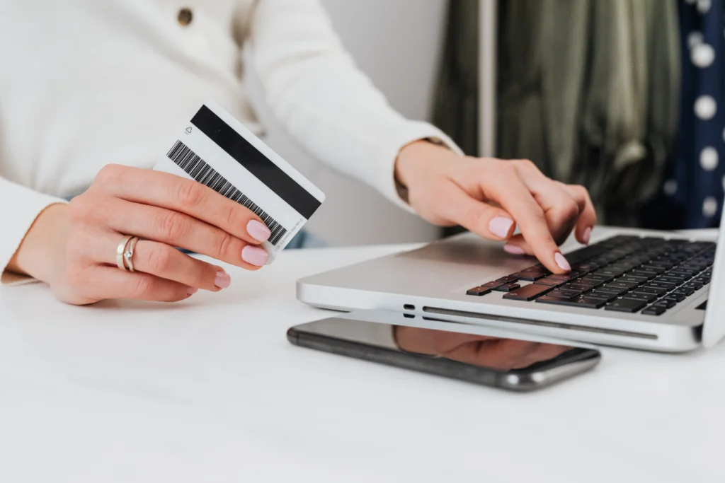 Parent making an online school payment with a credit card on a laptop, representing school payment portals and digital payment systems
