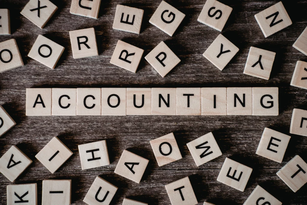 Wooden tiles spelling “accounting,” representing modern school accounting and management of payments, fees, and school-generated funds
